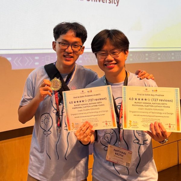 Nathan and a teammate on stage at ICPC Asia-Manila 2025, holding their First to Solve certificates