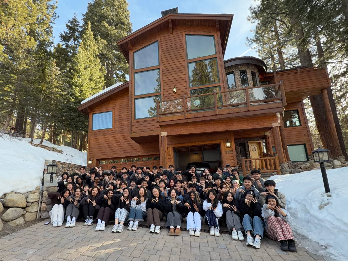 The AggieWorks team in front of a snowy cabin